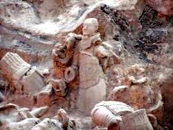 Terra Cotta figure still partially embedded in the earth surrounded by other pieces