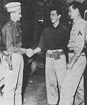 Maj Charles Stewart, 86th Observation Squadron Commander at Bellows, congratulates Pvt William L. Burt and PFC Raymond F. McBriarty, who were awarded the Silver Star for gallantry on 7 December 1941