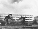 Hickam Field's big barracks, still burning from the Japanese attack