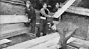 Indians unload Oregon timber at the Naval Supply Depot.