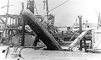 Photo # NH 90188:  Loading a torpedo into USS A-2, at the Cavite Navy Yard, circa 1912