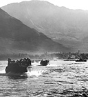 ARMY TROOPS IN LCP(L)'S, during an amphibious training exercise, leave
Oahu for a beach landing. After the entry of the United States into World War II
training was intensified, and specialized training in amphibious landings was
given the troops arriving in the Hawaiian Islands since most of the islands to be
taken later would have to be assaulted over open beaches. In February 1943 the
Amphibious Training Area, Waianae, Oahu, was activated for training units in
amphibious landings. LCP(L)'s had no bow ramp for disembarking troops.