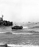 MEN AND SUPPLIES COME ASHORE in the Lingayen Gulf-San Fabian area