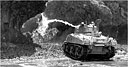 FLAME-THROWING MEDIUM TANK firing at the entrance of a cave on southern Okinawa