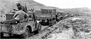 TRUCKS MOVING THROUGH THE MUD