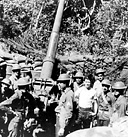 GUN CREW WITH A 3-INCH ANTIAIRCRAFT GUN M2. The U.S. troops moving 
southward down Bataan in front of the enemy forces continued their delaying
action as long as possible. The Bataan Peninsula, 32 miles long and 20 miles across
at the widest portion, is covered with dense woods and thick jungle growth.
Through the center runs a range of mountains. The limited area and difficult
terrain made the fighting more severe and added to the problems of the advancing
Japanese. However, the situation became steadily worse for the defending troops
and on 9 April 1942 the forces were surrendered to the Japanese.