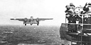 B-25'S ON THE FLIGHT DECK of the aircraft carrier USS Hornet before taking 
off to bomb Tokyo on 18 April 1942 (top); B-25 taking off from the flight
deck of the Hornet (bottom). In a small combined operation in the western
Pacific by the U.S. Navy and the Army Air Forces, sixteen planes took off from
the carrier Hornet, 668 nautical miles from Tokyo, to bomb the city for the first
time during the war. The Japanese were completely surprised because, even
though they had received a radio warning, they were expecting Navy planes
which would have to be launched from a carrier closer to Tokyo, and therefore
would not reach the city on 18 April.