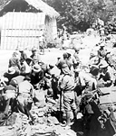 U.S. PRISONERS ON BATAAN sorting equipment while Japanese guards look
on. Following this, the Americans and Filipinos started on the Death March to
Camp O'Donnell in central Luzon. Over 50,000 prisoners were held at this
camp. A few U.S. troops escaped capture and carried on as guerrillas.
