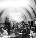 SOLDIERS IN MALINTA TUNNEL on Corregidor, April 1942. With food,
water, and supplies practically exhausted and no adequate facilities for caring
for the wounded, and with Japanese forces landing on Corregidor, the situation
for the U.S. troops was all but hopeless. The commander offered to surrender the
island forts on Corregidor to the Japanese. When this was refused and with the
remaining troops in danger of being wiped out, all the U.S. forces in the
Philippines were surrendered to the enemy on 6 May 1942. Couriers were sent
to the various island commanders and by 17 May all organized resistance in the
Philippines had ceased.