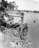 SOLDIERS PRACTICE LOADING into small boats during training in Australia.
Cargo nets on a transport could be used with a great degree of efficiency as they
could accommodate far more troops at one time than ladders.