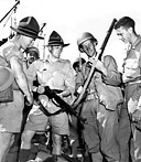 U.S. AND NEW ZEALAND SOLDIERS comparing weapons. The Australians
and New Zealanders took part in a number of the operations in the Southwest
Pacific Area.
