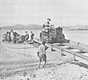 Figure 4.--Unloading tractors from 50-foot motor launch equipped 
with boat rig A and ramp.