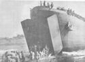 OUT OF THE JAWS OF A U.S. COAST GUARD-MANNED LST AT CAPE GLOUCESTER, NEW BRITAIN, COME THE MARINES