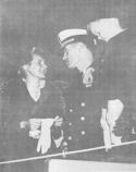 FOUR-YEAR-OLD RICHARD DEXTER SON OF COMMANDER DWIGHT H. DEXTER, U.S. COAST GUARD STUDIES WITH PUZZLED INTEREST THE NEW SILVER STAR HIS FATHER IS WEARING