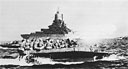 Main batteries of USS Tennessee hurl tons of high explosives at Okinawa as assault amtracs head for the beachhead.