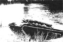 Figure 8. The early test version of the LVT(A)1 coming ashore. The armored canopy eventually became a tank turret, based on the Borg-Warner designed Model A.