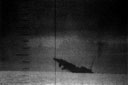 Struck by Torpedo Mark 14, enemy ship slips beneath the waves