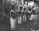 Lt. E. B. Proctor, USNR, gives orders of the day to native working party at Fergusson Island PT advance base