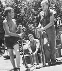 PT crewmen came young. Forrest Hall, S1c, USNR (left), 17 years old, helps Charles Ferguson, GM2c, USNR (right), and Carl Ochsner, CMM, USNR, bring .50-caliber ammunition aboard his boat at Dreger Harbor.