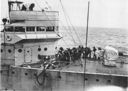 Fleet Problem XIII. The crew of a destroyer takes in the 10-inch towing line in preparation for fueling at sea.