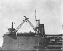 Image: 80-G-3270l USS Curtiss, showing starboard crane which was struck by Japanese aircraft out of control.