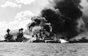 Image: 80-G-33058 USS Arizona burning after the magazine explosion. The ship forward is USS Tennessee which is playing water over the stern to keep oil fires from Arizona at a distance. USS West Virginia is on the far left.