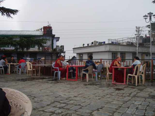 rooftop teahouse with monks