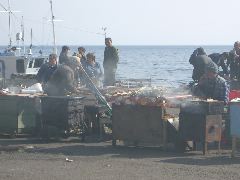 grilling fish at the market at port