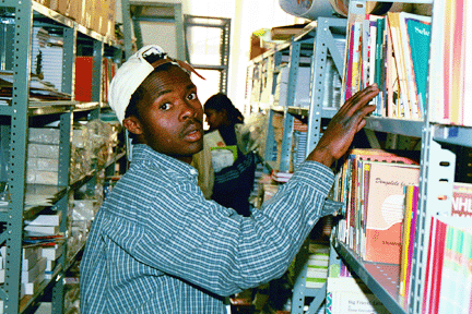 Herman Mongoale, chairman of the Carrie Community library committee, chooses new African books at READ Educational Trust.
