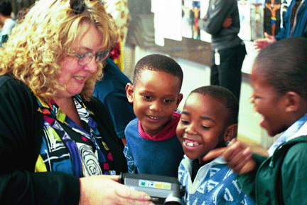 These orphans in Pretoria are thrilled with a glimpse at themselves through WLP volunteer Debbie Kilcup's digital camera.