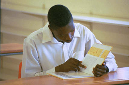 A student reads a new book at DD Mabuza library.