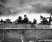 Photo # 26-G-2349:  Troops and crewmen aboard a Coast Guard manned LCVP as it approaches a beach on D-Day, 6 June 1944
