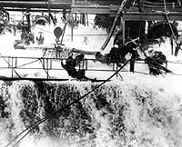 Photo # 80-G-13106:  A wave engulfs the hose crew on USS Neosho as she refuels USS Yorktown, early May 1942