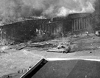 Photo # 80-G-19944:  Planes and a hangar burning at the Ford Island Naval Air Station's seaplane base, during or immediately after the 7 December 1941 Japanese raid on Pearl Harbor.