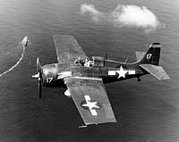 Photo # 80-G-287594:  FM-2 fighter over USS Santee during the Leyte invasion, Oct. 1944