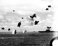 Photo # 80-G-32242:  Twp Japanese torpedo planes fly past USS Yorktown after dropping their torpedoes, 4 June 1942