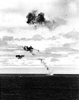 Photo # 80-G-32250:  A Japanese torpedo plane crashes while attempting to attack USS Yorktown, 4 June 1942