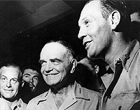 Photo # 80-G-44089:  Adm. William F. Halsey (center) with Cdr. Joseph C. Clifton (right) on board USS Saratoga, 1943
