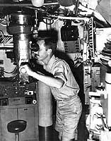 Photo # 80-G-49459:  Officer looks through one of USS Bullhead's periscopes, circa Spring 1945.