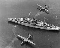Photo #  80-G-483681:  USS Timbalier tending two Martin PBM Mariner seaplanes soon after World War II.