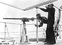 Photo # NH 41702:  Officer firing a signal gun on board USS DeKalb, 18 May 1918