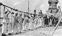 Photo # NH 44422:  Crewmen cleaning USS Oklahoma's after 14-inch guns, circa 1916