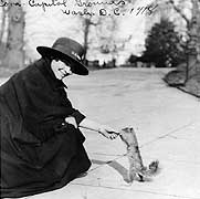 Photo # NH 65586: Yeoman (F) Cora Dell Croft feeds a squirrel on the Capitol Grounds, Washington, D.C., 1918