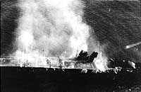 Photo # NH 73064:  Japanese aircraft carrier Hiryu burning shortly after sunrise on 5 June 1942, a few hours before she sank.