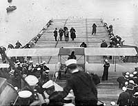 Photo # NH 77591:  Photographing Ely's plane aboard USS Pennsylvania, 18 January 1911