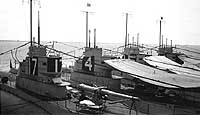 Photo # NH 90306:  USS S-4 with three other 'S-boats' at Cavite Navy Yard, 1923-1924