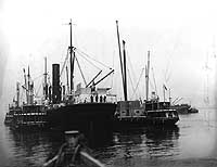 Photo # NH 96062:  Catherine Johnson and other lighters alongside a British freighter, 5 May 1917