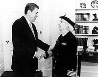 Photo # NH 96926: President Ronald Reagan congratulates Commodore Grave M. Hopper following her promotion from the rank of Captain, December 1983