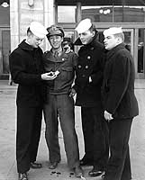 Photo # NH 96984: Sailors from USS Boxer with a South Korean interpreter, during a visit to Seoul, April 1950