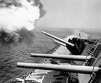 Photo # NH 97185: USS Manchester firing on enemy shore batteries, from off Wonsan, North Korea, 1953